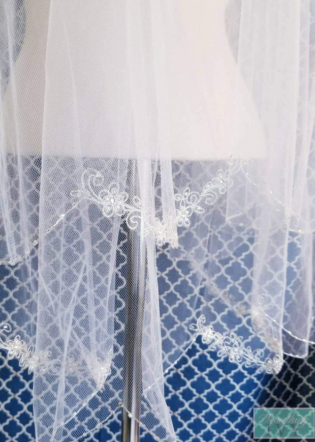 https://somethingivy.com/cdn/shop/products/36-two-tier-silver-embroidered-edge-veil-scallop-edge-veil-embroidered-veils-two-tier-veils-fold-over-veils-circle-cut-veil-2_92e28f94-7d4c-4915-ab4c-3bd090854d44_620x.jpg?v=1591500482